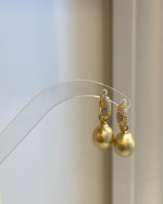 Golden pearls with soft natural variations in color and shape.