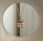 Handbag pendant necklace with six ivory Akoya pearls and a crystal-accented gold-tone setting