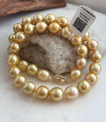 Golden South Sea pearls arranged together in a necklace