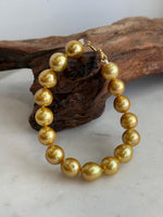 Detail of the natural golden color and reflective surface of the Edison pearls.