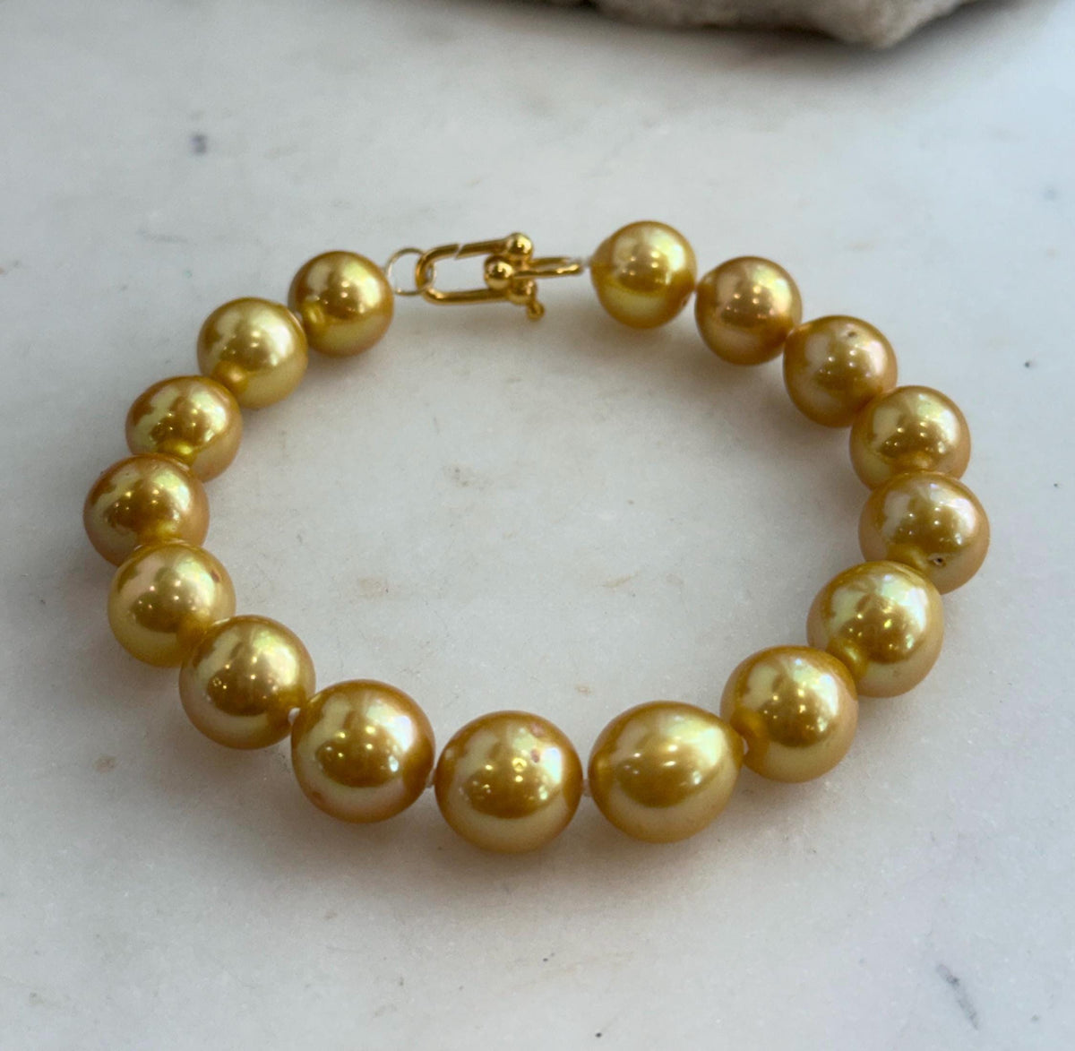 Golden Edison pearl bracelet with warm tones and a polished sterling silver clasp.