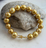 Golden Edison pearl bracelet with richly colored freshwater pearls and a sterling silver clasp.