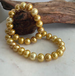 Close view of genuine Edison pearls showing their reflective surfaces and golden color.