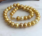 Golden Edison pearls displaying warm color variations along the necklace.