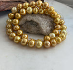 Finished golden pearl necklace with large Edison pearls and traditional hand knotting.