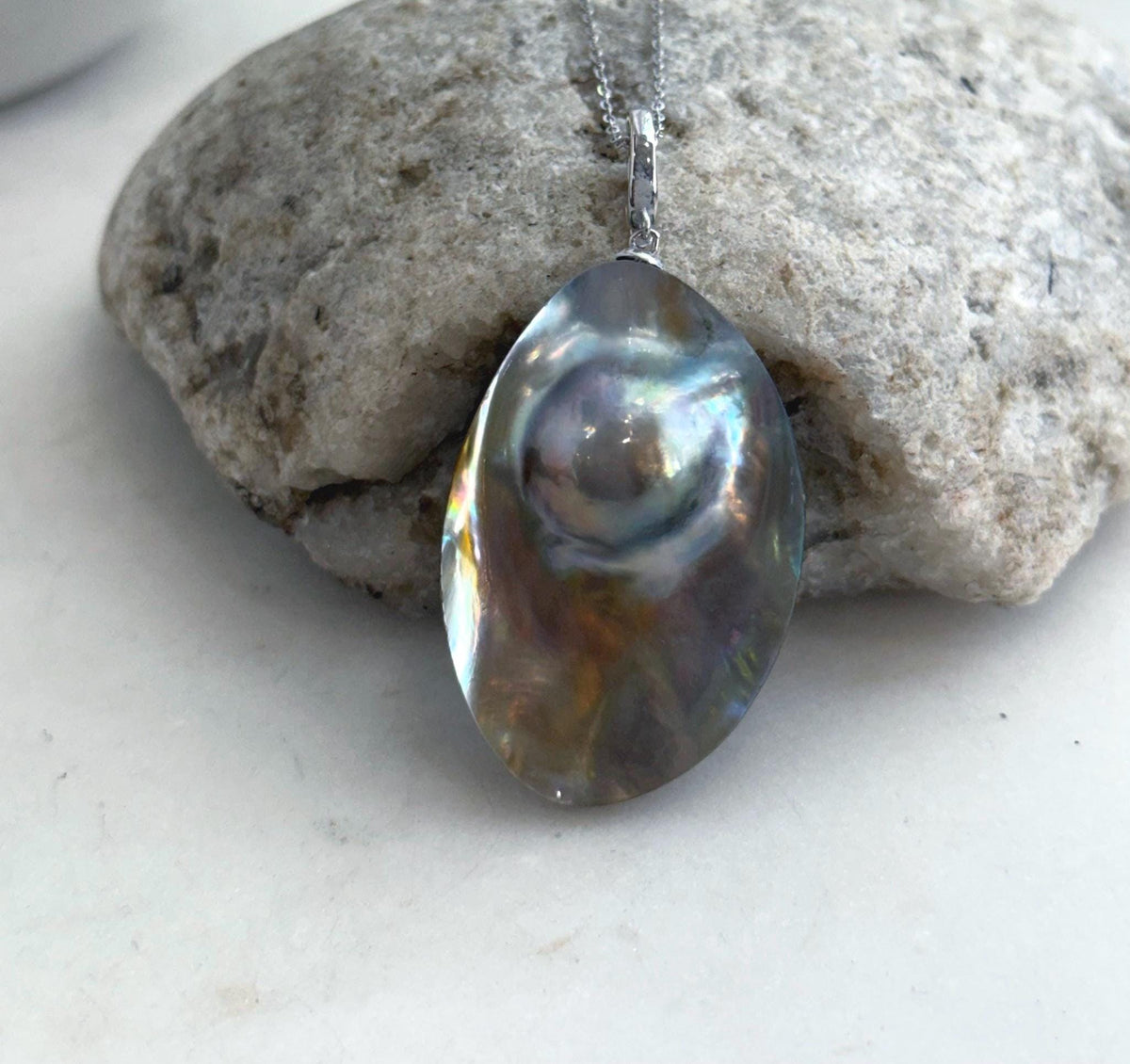 Close-up of the ocean Mabe pearl’s shifting iridescent colors