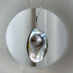 Angled view showing the pearl’s color and reflective luster