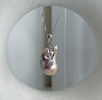 Two luminous white baroque pearls with naturally unique shapes