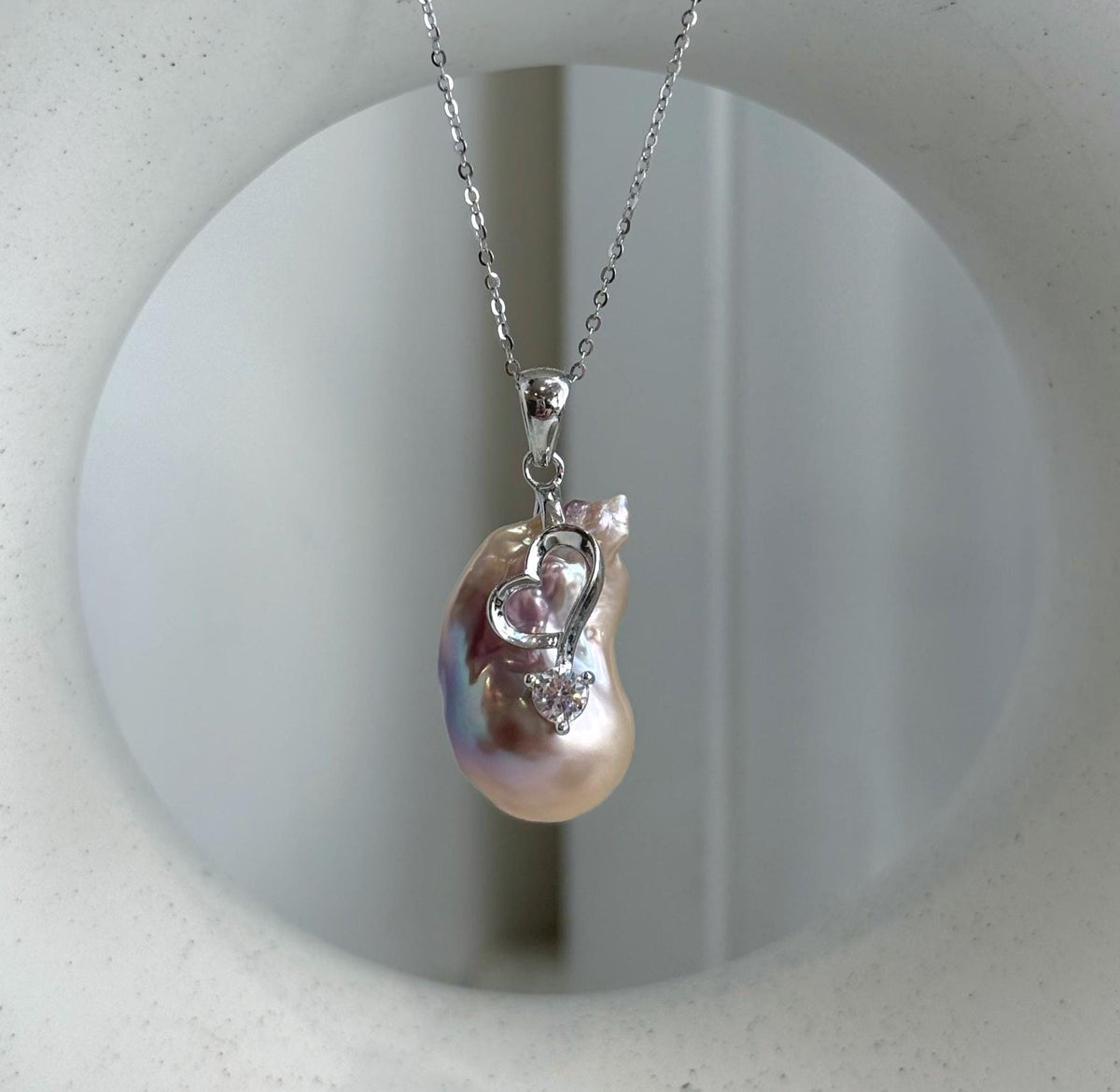 Two luminous white baroque pearls with naturally unique shapes