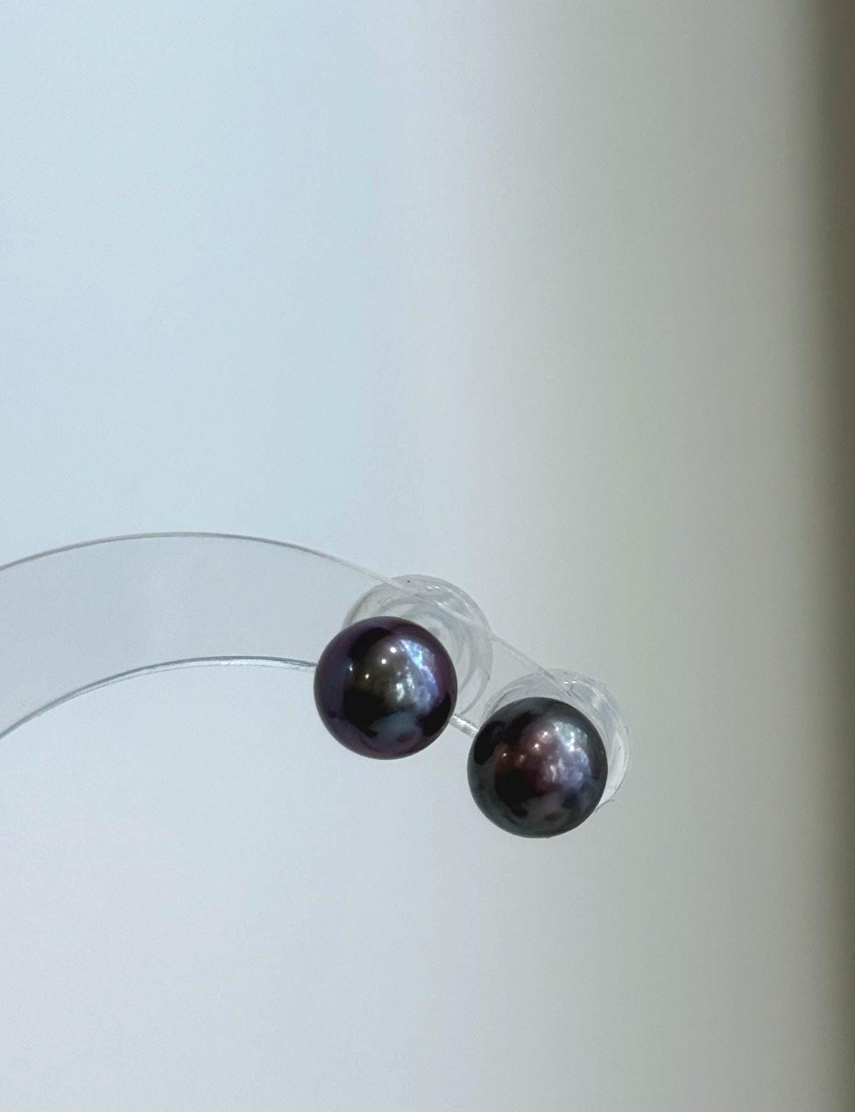 Minimalist purple pearl studs featuring genuine freshwater pearls and sterling silver settings.