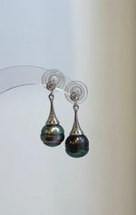Pair of Tahitian pearl earrings with cool-toned sterling silver details.