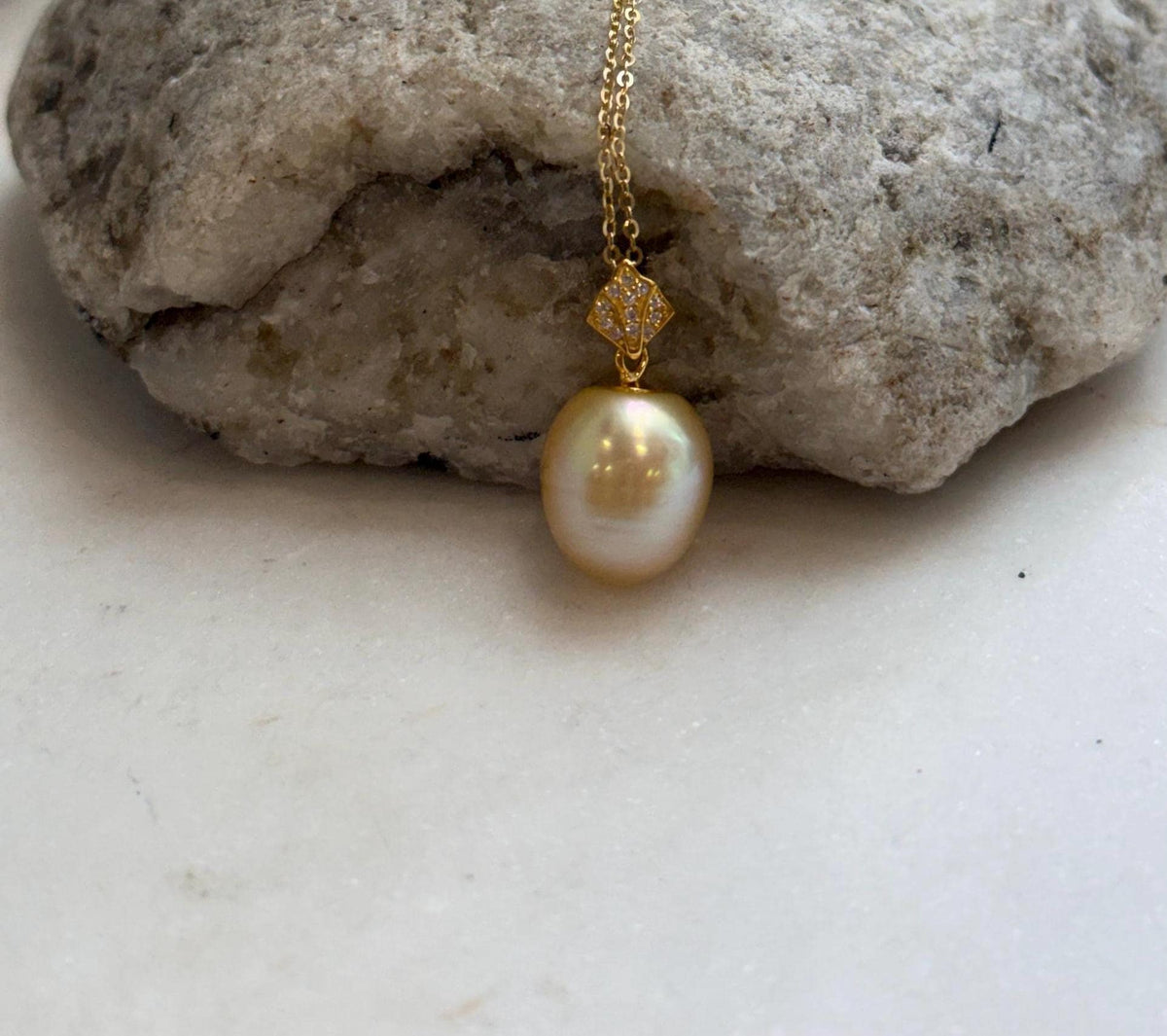 Close-up of the genuine golden South Sea pearl and its bright, reflective luster.