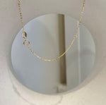 Close-up of the drop-shaped pearl’s warm golden colour and smooth surface.