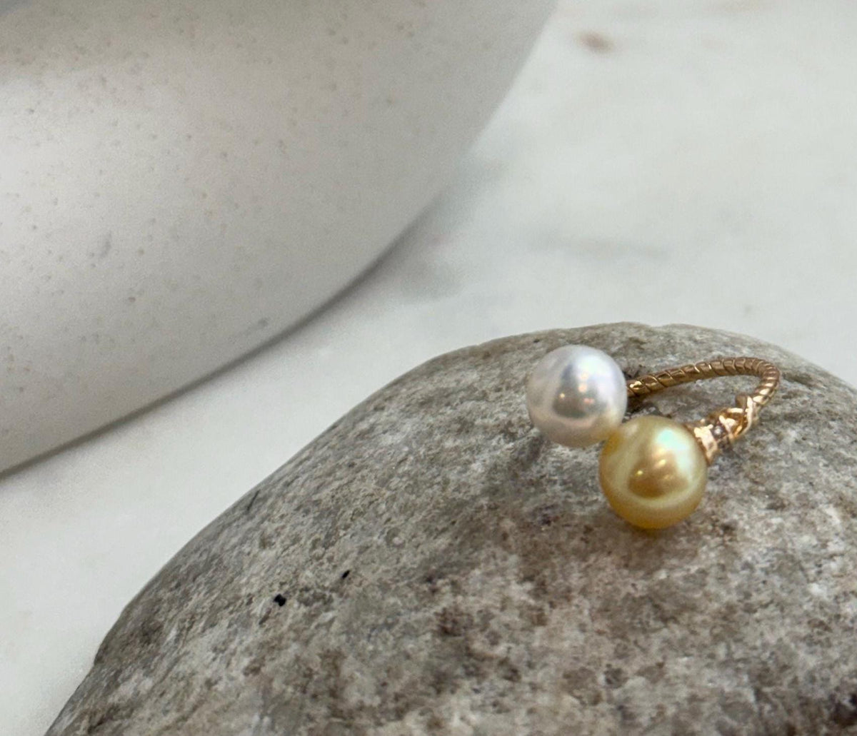 Elegant adjustable sterling silver ring set with two high-luster golden freshwater pearls.