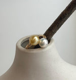 Minimalist double pearl ring with luminous golden freshwater pearls and a sterling silver band.