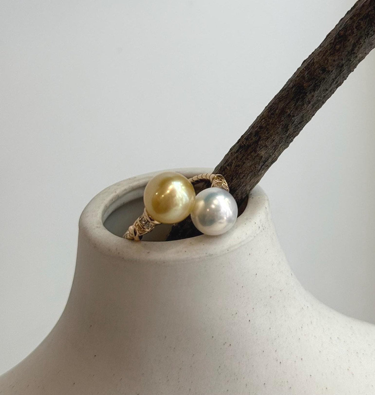 Minimalist double pearl ring with luminous golden freshwater pearls and a sterling silver band.