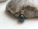 Close-up of a lustrous piano black Tahitian pearl pendant