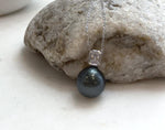 Elegant black pearl necklace featuring a bright, reflective surface