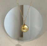 Luxury 18K gold pearl pendant featuring a large South Sea golden ocean pearl.