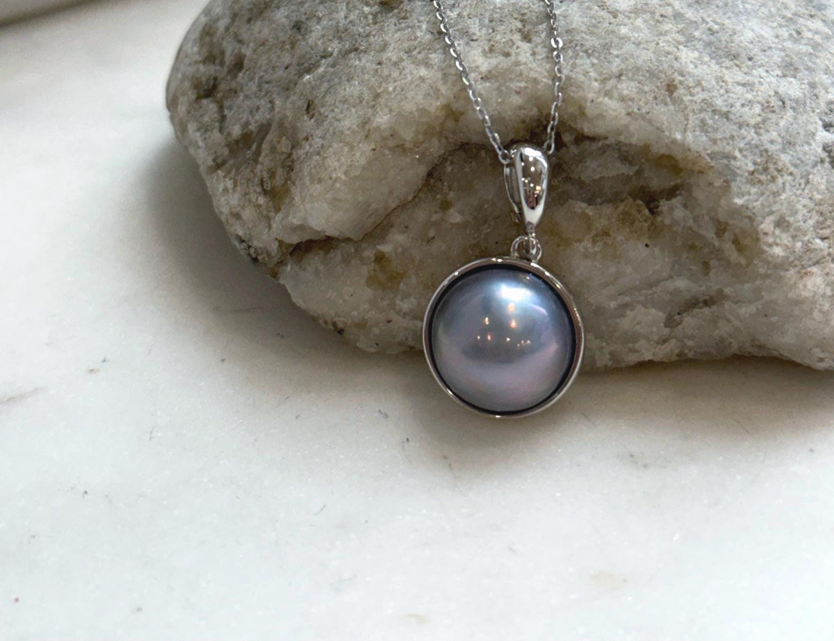 Iridescent Mabe pearl jewelry with luminous platinum overtones and sterling silver setting