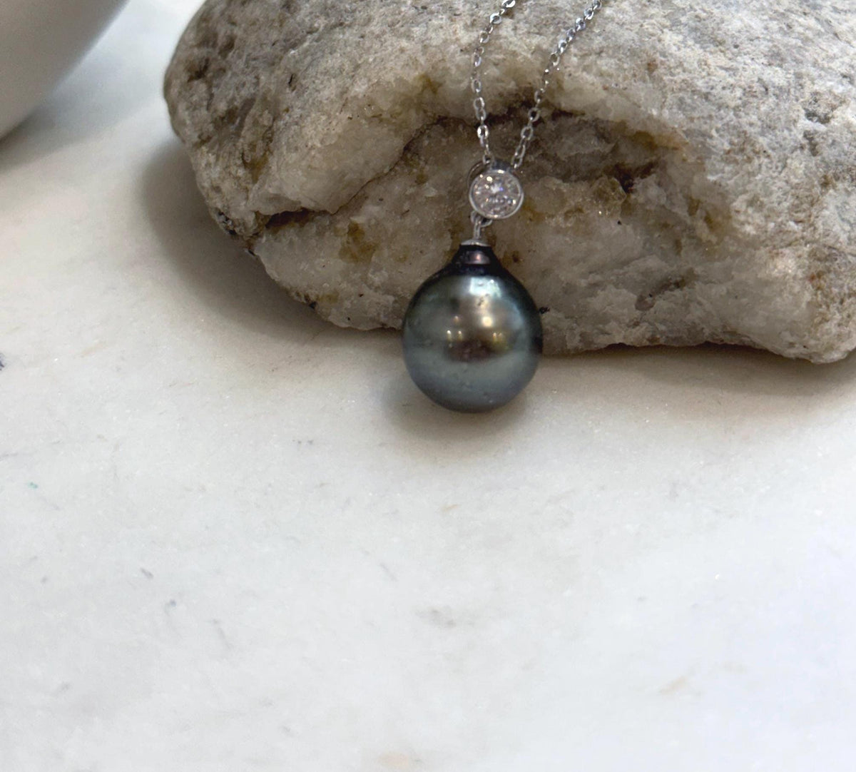 Crystal-accented silver pendant with a peacock saltwater pearl.