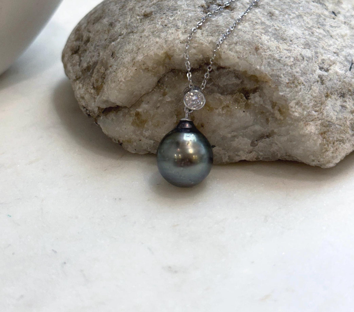 Lustrous green Tahitian pearl in a crystal-accented pendant.