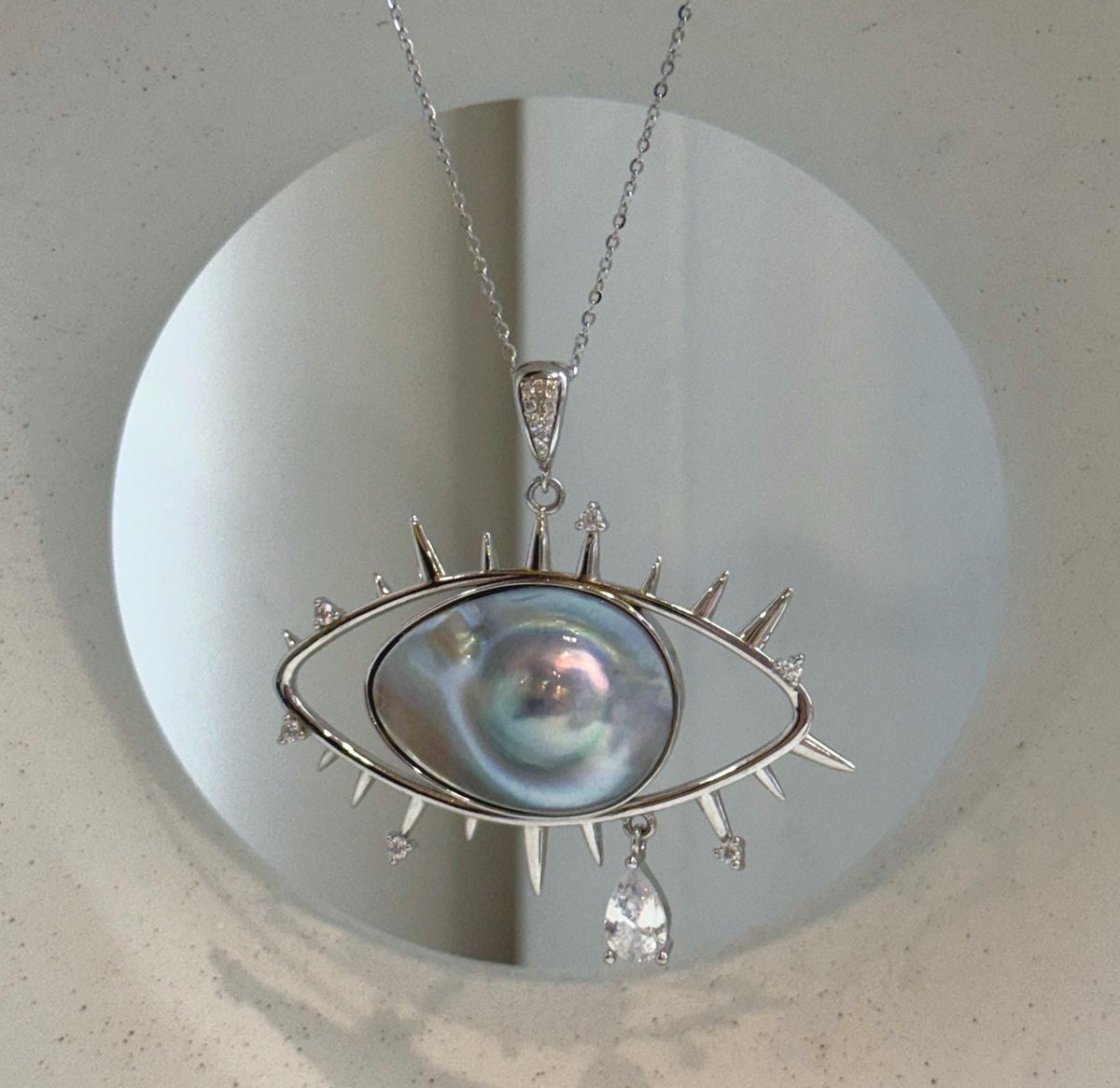 Unique eye-shaped pearl statement pendant necklace by Elly