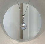 Minimalist pearl pendant featuring a lustrous silver pearl.