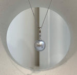 Lustrous pearl paired with a minimalist sterling silver setting.