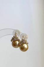 Lustrous golden pearls in S925 sterling silver crown settings.