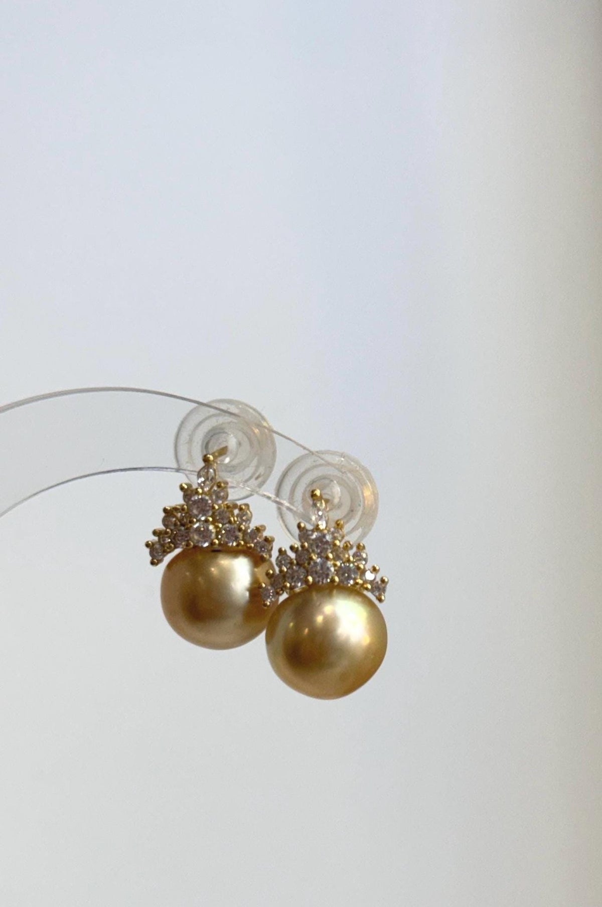 Lustrous golden pearls in S925 sterling silver crown settings.
