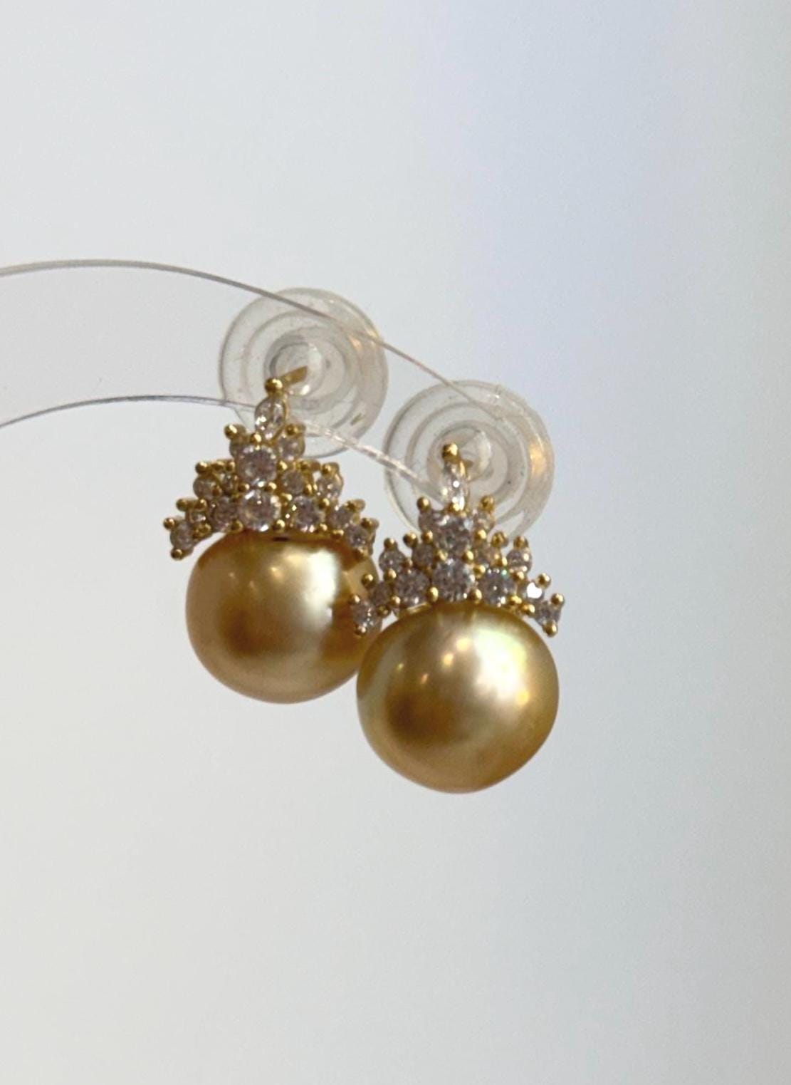 South Sea pearl earrings featuring sterling silver crown settings.