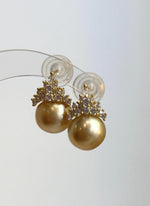South Sea pearl earrings featuring sterling silver crown settings.