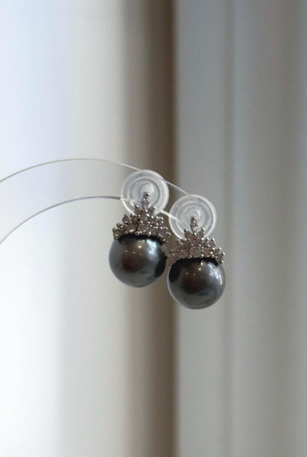 Platinum gray pearl studs with sparkling crystal crowns.