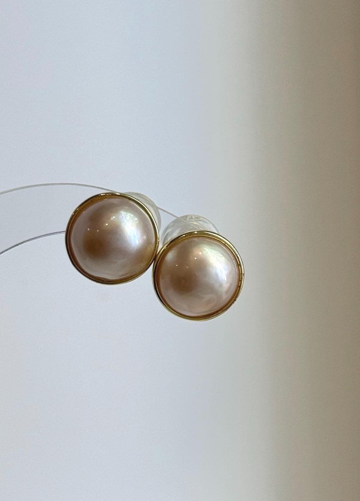 Ivory iridescent Ocean Mabe pearl stud earrings with extreme mirror luster