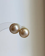 Round ivory pearl stud earrings with beautiful iridescent overtones