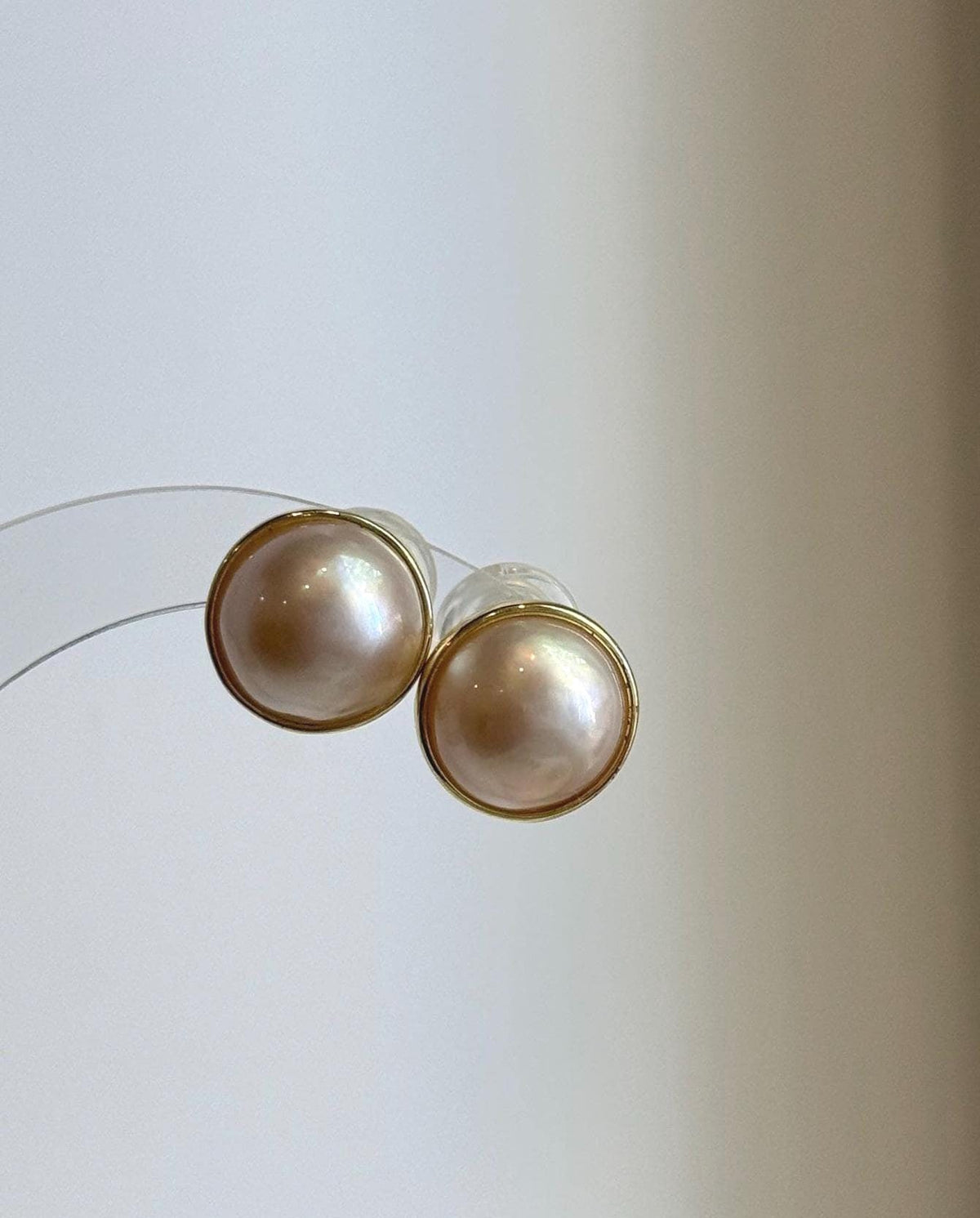 Round ivory pearl stud earrings with beautiful iridescent overtones