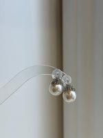 Extreme mirror-luster South Sea pearl earrings photographed in natural light