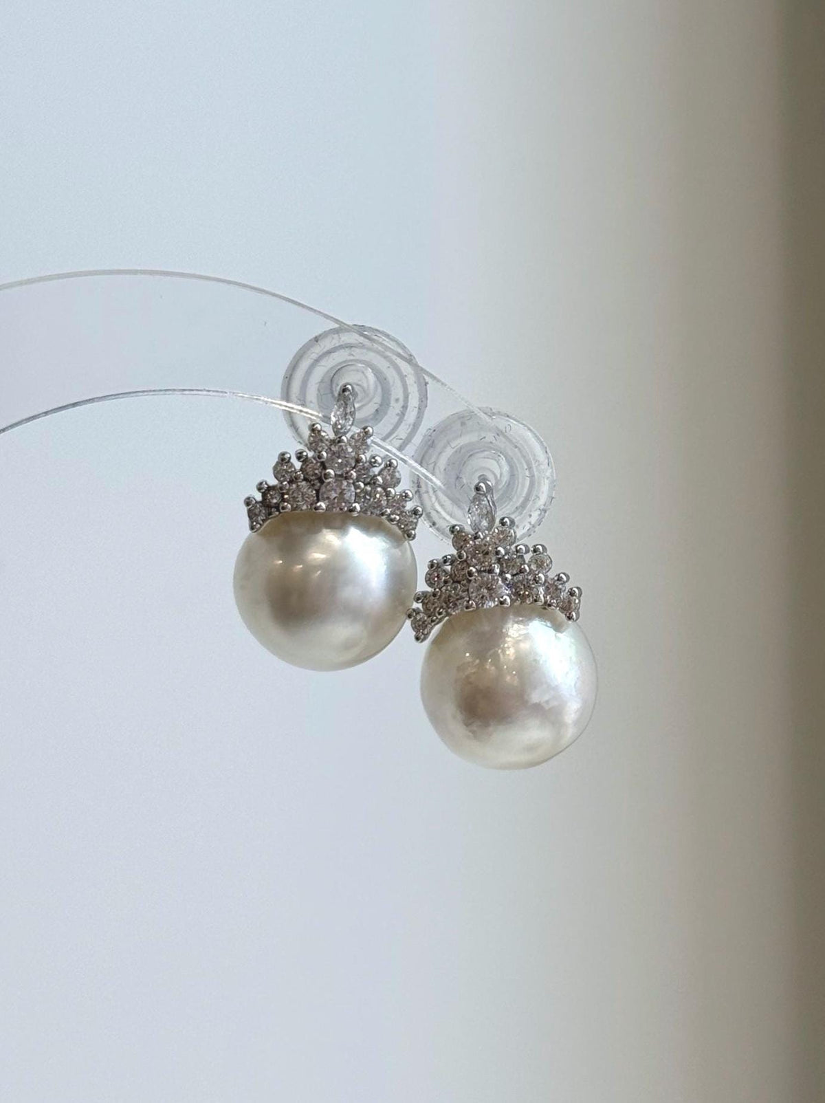 Luxury white pearl crown stud earrings with brilliant silver details