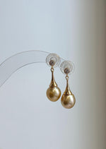 Luxury golden pearl drop earrings with elegant tapered settings