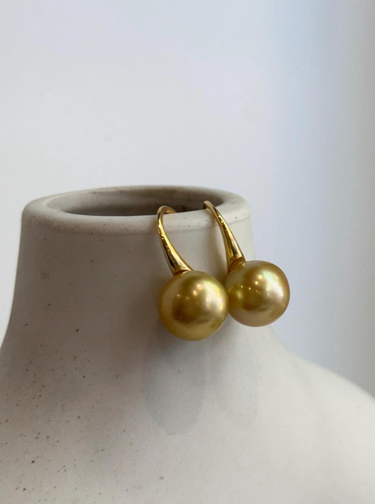 South Sea golden pearl earrings with high heel hook details.