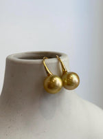 South Sea golden pearl earrings with high heel hook details.