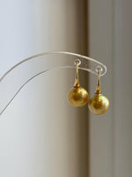 Golden South Sea pearl drops with silver high heel accents.
