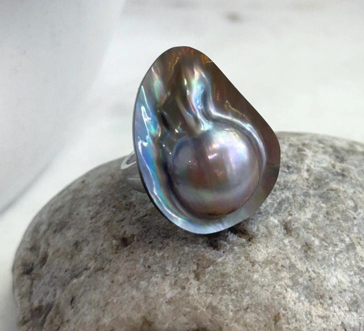 Large rainbow mabe pearl set in sterling silver.