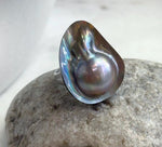Large rainbow mabe pearl set in sterling silver.
