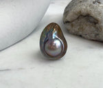 Bold mabe pearl statement ring with radiant luster.