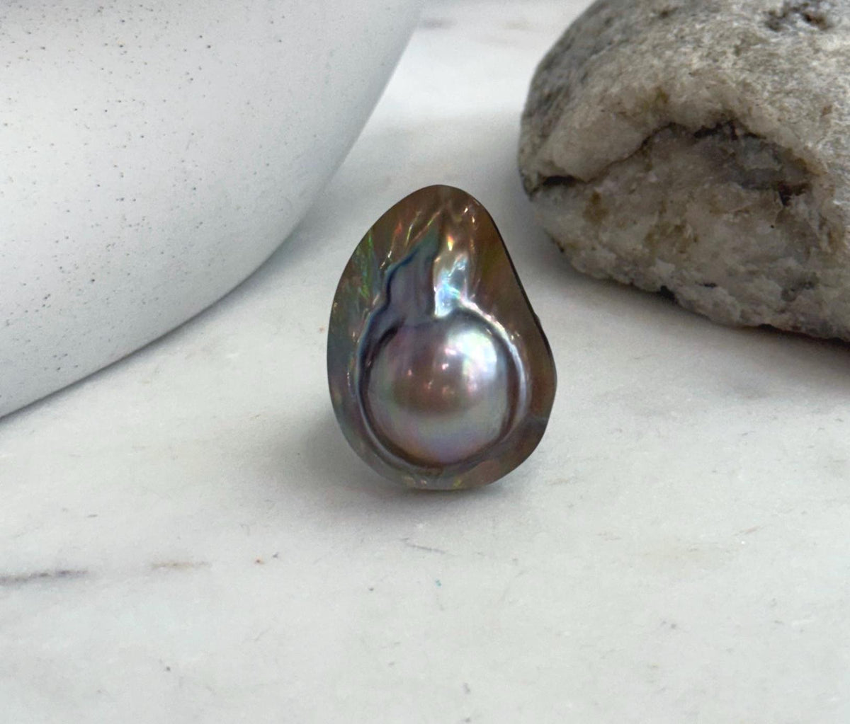Bold mabe pearl statement ring with radiant luster.