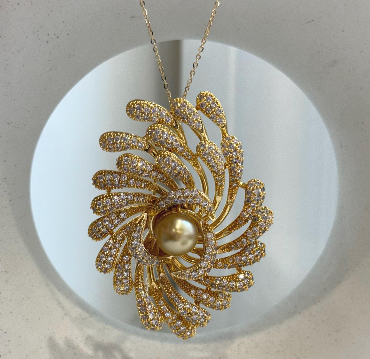 Art Deco style pearl brooch featuring a lustrous South Sea golden pearl