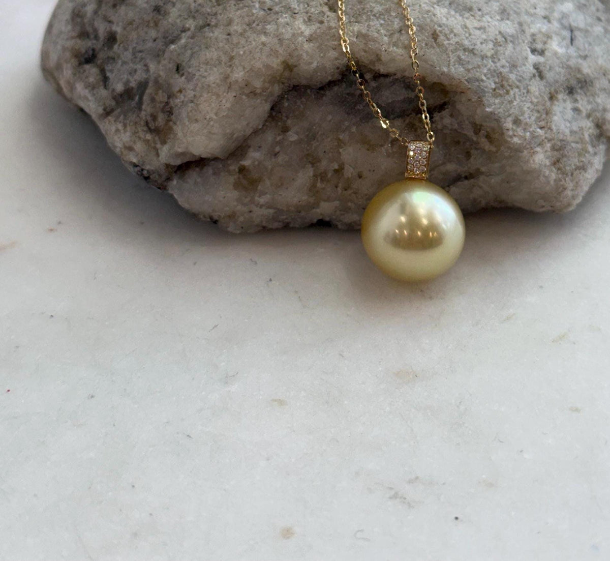 Large golden saltwater pearl with mirror luster.