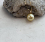 Large golden saltwater pearl with mirror luster.